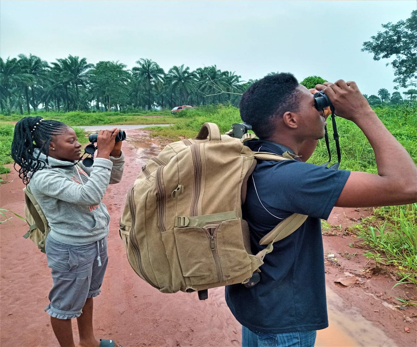 Members of Ibom Bird Club Uyo, doing what they love! Photo shows Mr. Inemesit Eniang on the right and one of the Award winning 100th Conservation Youth leaders in Africa 2021 – Miss Eunice Eniang on the left searching for Birds / vultures. Photo: Etido Udofia